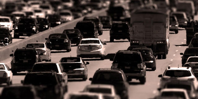 Traffic begins to thicken as motorists getting an early jump to Memorial Day destinations in Indiana and Michigan travel an interstate freeway through Chicago Friday, May 24, 2013. (AP Photo/Charles Rex Arbogast)