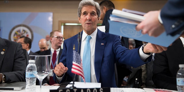Secretary of State John Kerry is handed notes as he sits down for the General Assembly of the Organization of American States, Tuesday, June 14, 2016, in Santo Domingo, Dominican Republic. (AP Photo/Evan Vucci, Pool)