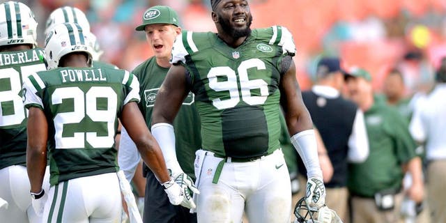 Dec 28, 2014; Miami Gardens, FL, USA; New York Jets defensive end Muhammad Wilkerson (96) laughs on the sideline during the second half against the Miami Dolphins at Sun Life Stadium. Mandatory Credit: Steve Mitchell-USA TODAY Sports