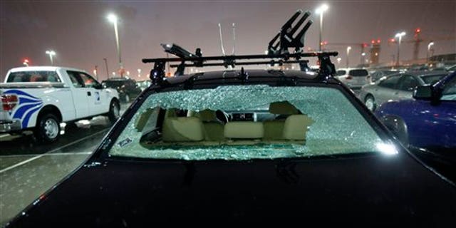 May 24: The rear windshield of a parked car at Love Field Airport in Dallas was shattered by hail during severe weather that also produced a tornado nearby.