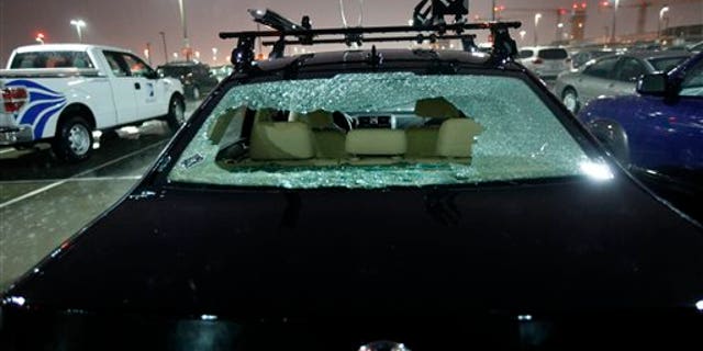May 24: The rear windshield of a parked car at Love Field Airport in Dallas was shattered by hail during severe weather that also produced a tornado nearby.