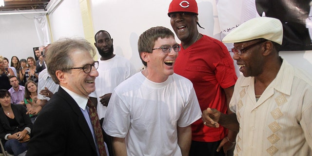 Sept 28: With attorney Barry Scheck, left, founder of the Innocence Project, at his side,  Damon Thibodeaux shares a laugh with previously exonerated men Derrick James, second from right, and Ricky Johnson  upon arrival at a press conference.