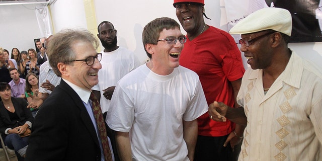 Sept 28: With attorney Barry Scheck, left, founder of the Innocence Project, at his side, Damon Thibodeaux shares a laugh with previously exonerated men Derrick James, second from right, and Ricky Johnson upon arrival at a press conference.