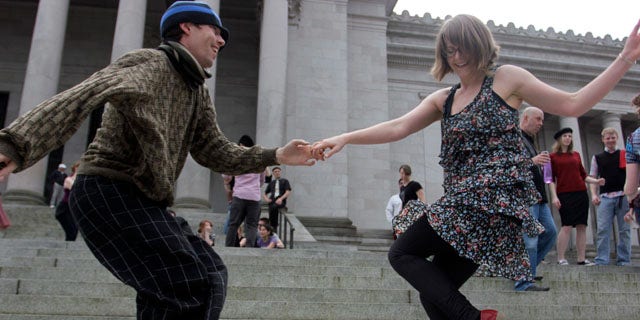 April 1, 2013: Melissa Petersen and Kevin Buster dance on the steps of the Capitol in Olympia, Wash.
