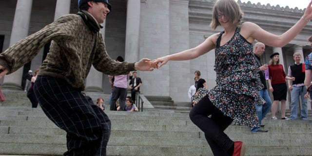 April 1, 2013: Melissa Petersen and Kevin Buster dance on the steps of the Capitol in Olympia, Wash.