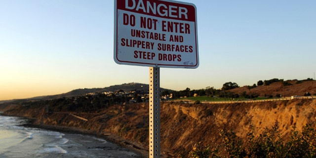 A Danger sign at Point Fermin Park in San Pedro, Calif. on Monday, January 8, 2007. The body of USC kicker Mario Danelo, 21, was found at the bottom of the rocky San Pedro cliff on Jan. 6. Los Angeles Police Department officials have ruled the death either an accident or suicide. (Photo by Kirby Lee/Getty Images)