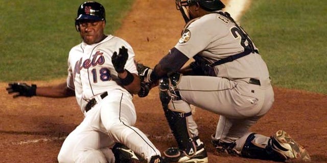 Aug. 23, 1999: New York Mets' runner Darryl Hamilton (L) is out at the plate on a tag by Houston Astros' catcher Tony Eusebio in the fourth inning at New York's Shea Stadium.