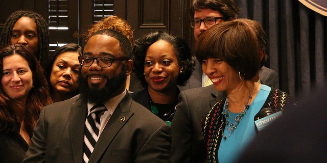 Darryl Strange, pictured with Baltimore Mayor Catherine Pugh, was a city police officer between 2006 and 2011.