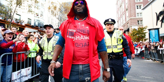 BOSTON, MA - NOVEMBER 02: David Ortiz #34 of the Boston Red Sox walks down Boylston Street near the finish line of the Boston Marathon during the World Series victory parade on November 2, 2013 in Boston, Massachusetts. (Photo by Jared Wickerham/Getty Images)