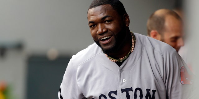 Boston Red Sox's David Ortiz reacts in the dugout after he scored a run in the second inning after hitting a double against the Seattle Mariners, Wednesday, July 10, 2013, in Seattle. With the hit, Ortiz' 1689th in his MLB career, he passed the record held by Harold Baines for the most hits as a designated hitter in major league history. (AP Photo/Ted S. Warren)