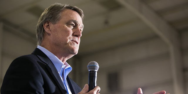 ATLANTA, GA - NOVEMBER 03:   Republican candidate for U.S. Senate David Perdue (R) speaks at a campaign stop one day before the mid-term elections at Peachtree Dekalb Airport on November 3, 2014 in Atlanta, Georgia.  Perdue is in a tight race with Democratic challenger Michelle Nunn. (Photo by Jessica McGowan/Getty Images)