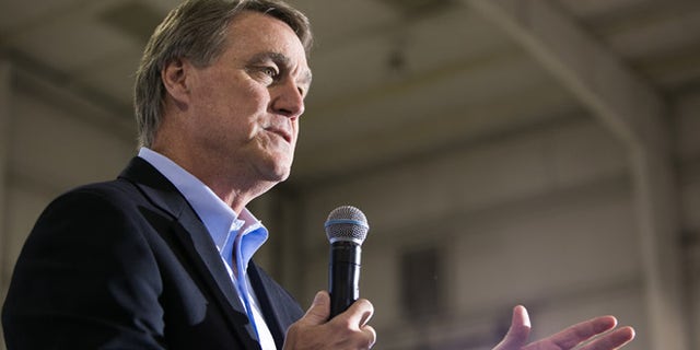 ATLANTA, GA - NOVEMBER 03: Republican candidate for U.S. Senate David Perdue (R) speaks at a campaign stop one day before the mid-term elections at Peachtree Dekalb Airport on November 3, 2014 in Atlanta, Georgia. Perdue is in a tight race with Democratic challenger Michelle Nunn. (Photo by Jessica McGowan/Getty Images)