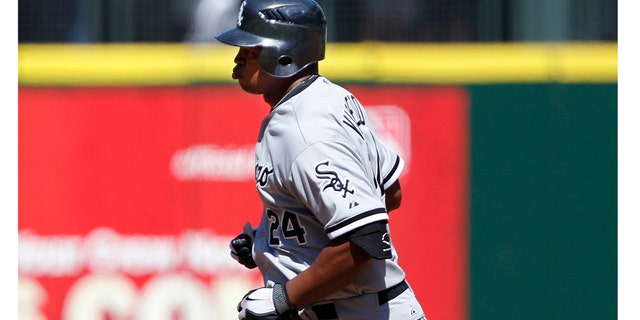 Chicago White Sox Dayan Viciedo rounds the bases on his three-run home run against Seattle Mariners in the fourth inning of a baseball game, Sunday, Aug. 28, 2011, in Seattle. (AP Photo/Elaine Thompson)