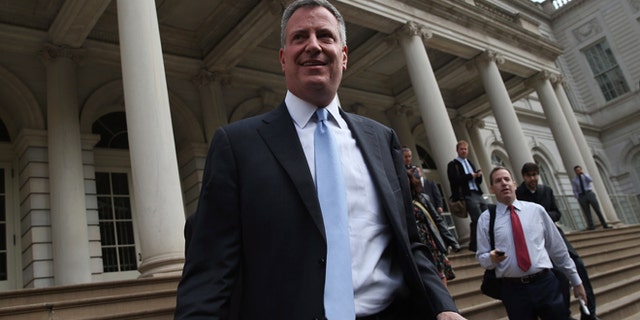 NEW YORK, NY - NOVEMBER 06: New York City Mayor-elect Bill de Blasio leaves City Hall after meeting with outgoing Mayor Michael Bloomberg on November 6, 2013 in New York City. It was the first meeting between the two since de Blasio's election victory the day before. (Photo by John Moore/Getty Images)