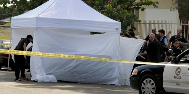 August 24, 2014: Los Angeles Police Department officers investigate the scene of a shooting where one person was killed near the 14400 block of Polk Street in Sylmar, Calif. (AP Photo/Los Angeles Daily News, Dean Musgrove)