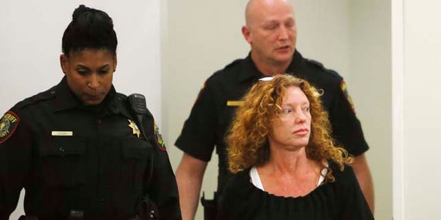 Deputies escort Tonya Couch, front right, to the defense table before her bond reduction hearing Monday, Jan 11, 2016, in court in Fort Worth, Texas. Couch, the mother of a Texas teenager who used an "affluenza" defense for a deadly wreck, could soon leave jail after a judge on Monday sharply reduced her bond. (David Kent/Star-Telegram via AP, Pool)