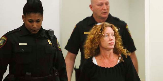 Deputies escort Tonya Couch, front right, to the defense table before her bond reduction hearing Monday, Jan 11, 2016, in court in Fort Worth, Texas. Couch, the mother of a Texas teenager who used an "affluenza" defense for a deadly wreck, could soon leave jail after a judge on Monday sharply reduced her bond. (David Kent/Star-Telegram via AP, Pool)