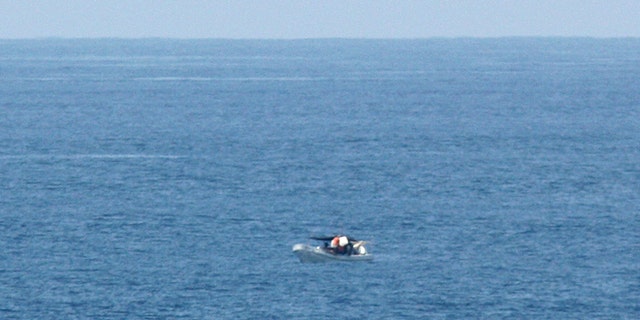 March 10, 2012: A passenger of the American-based cruise ship Star Princess, shows a fishing vessel adrift in the Pacific Ocean off the Galapagos Islands.