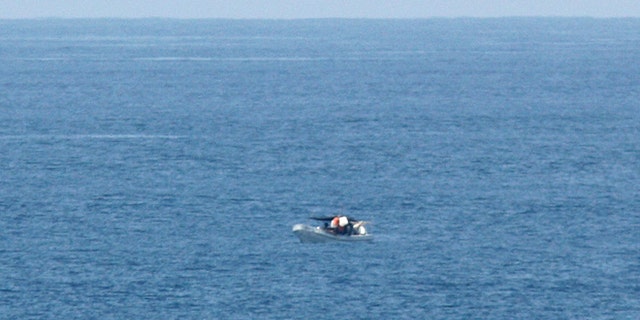March 10, 2012: A passenger of the American-based cruise ship Star Princess, shows a fishing vessel adrift in the Pacific Ocean off the Galapagos Islands.