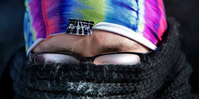 FILE: January 6, 2014: The cold weather makes vision challenging as Jobin Curow's glasses fog up while walking in subzero temperatures on the Lawrence University campus in Appleton, Wis.