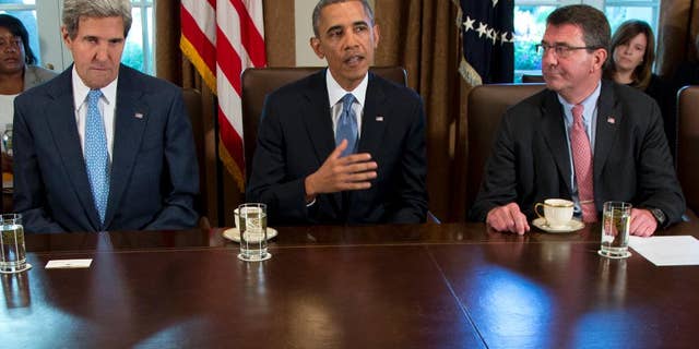 FILE - In this Sept. 30, 2013 file photo, then-Deputy Defense Secretary Ashton Carter, right, listens a President Barack Obama speaks to members of the media in the Cabinet Room of the White House in Washington. Carter has emerged as President Barack Obama's top candidate to become the next defense secretary, according to administration officials, putting him in line to take over a sprawling department that has had an uneasy relationship with the White House. Secretary of State John Kerry is at left. (AP Photo/Carolyn Kaster, File)