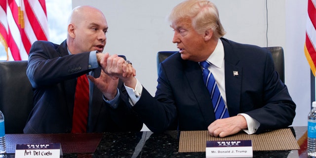 CORRECTS SPELLING OF DEL CUETO - Republican presidential candidate Donald Trump shakes hands with Art Del Cueto during a meeting with members of the National Border Patrol Council at Trump Tower, Friday, Oct. 7, 2016, in New York. (AP Photo/ Evan Vucci)