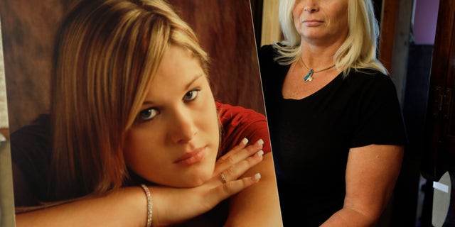 Oct. 3, 2013: Lisa Moore displays a photo of her daughter, Alexis, in her home in Terre Haute, Ind.