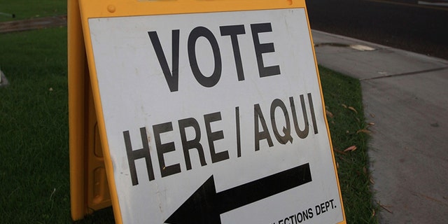 PHOENIX - NOVEMBER 4: A bilingual sign announces a polling place in the home state of Republican presidential nominee U.S. Sen. John McCain (R-AZ) November 4, 2008 in Phoenix, Arizona. Voting is underway in the U.S. presidential elections with Democratic presidential nominee Sen. Barack Obama (D-IL) leading in the polls against the Republican presidential nominee Sen. John McCain (R-AZ). (Photo by David McNew/Getty Images)