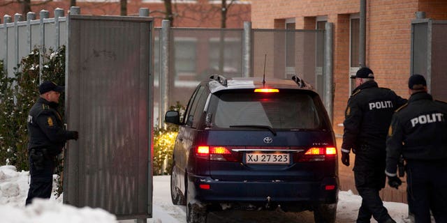 Dec. 30: Danish police officers stand guard as a suspect arrested on suspicion of planning a shooting attack on the office of a newspaper that published cartoons of the Prophet Muhammad arrives at a court in Glostup, south of Copenhagen.