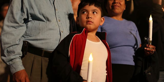 HOMESTEAD, FL - JANUARY 06: Rodrigo Hernandez, whose family is originally from Guatemala, attends a vigil with his family to protest against the deportation of undocumented immigrants on January 6, 2016 in Homestead, Florida. President Barack Obama's administration has begun a series of large-scale raids against hundreds of undocumented immigrants across the US, which is generating outrage among pro-immigrant groups who reject the measure. (Photo by Joe Raedle/Getty Images)