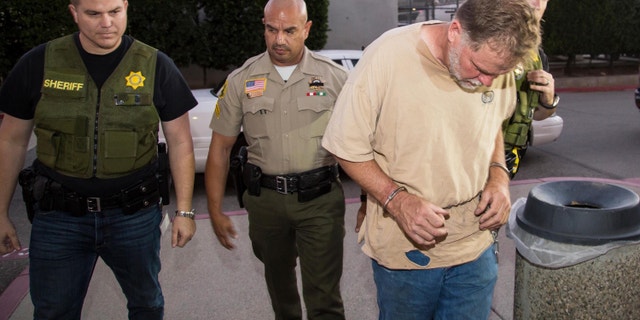 Nov. 5, 2014: This photo provided by the San Bernardino County Sheriff's office shows investigators from the San Bernardino County Sheriffs Department Homicide unit take Charles Merritt into custody for the murders of Joseph, Summer, Gianni and Joseph M. McStay in Victorville, Calif. (AP/San Bernardino County Sheriff)