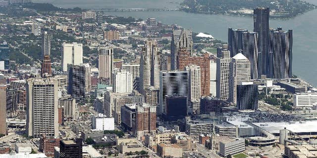 In this July 16, 2013 aerial file photo, the downtown of the city of Detroit is shown. Detroit Emergency Manager Kevyn Orr raised more than a few eyebrows a year ago when he took the city into bankruptcy and predicted it would be out by the time his term expired in fall 2014. Because it is by far the largest city to file for municipal bankruptcy and the issues were so complex many experts predicted it would take years to resolve. But the city will take a major step toward that goal with a trial in federal bankruptcy court that starts Tuesday, Sept 2, 2014. (AP Photo/Paul Sancya, File)
