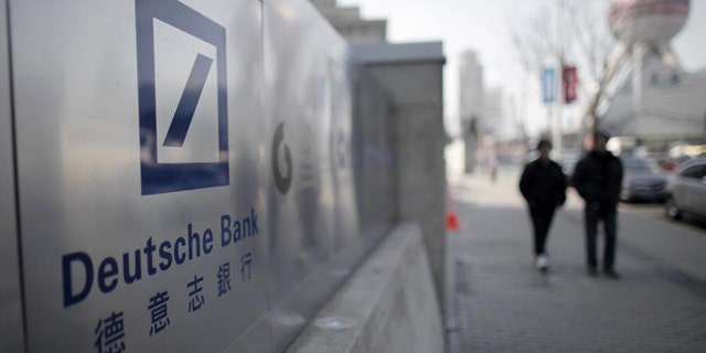 A Deutsche Bank sign is seen outside of a corporate building in Shanghai's financial district February 23, 2011. REUTERS/Carlos Barria
