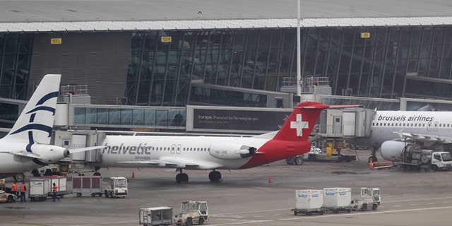 Feb. 19: Baggage carts make their way past a Helvetic Airways aircraft from which millions' of dollars worth of diamonds were stolen on the tarmac of Brussels international airport.