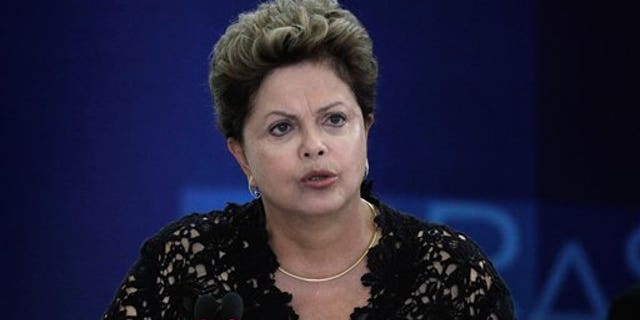 Brazil's President Dilma Rousseff speaks during a ceremony to present six new ministers to her cabinet, at the Planalto Presidential Palace, in Brasilia, Brazil, Monday, March 17, 2014. President Rousseff announced changes in her Cabinet with an eye on the October elections in which some of her former ministers will run for Congress and regional government posts. (AP Photo/Eraldo Peres)