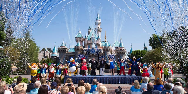 ANAHEIM, CA - JULY 17: In this handout photo provided by Disney parks, Mickey Mouse and his friends celebrate the 60th anniversary of Disneyland park during a ceremony at Sleeping Beauty Castle featuring Academy Award-winning composer, Richard Sherman and Broadway actress and singer Ashley Brown July 17, 2015 in Anaheim, California. Celebrating six decades of magic, the Disneyland Resort Diamond Celebration features three new nighttime spectaculars that immerse guests in the worlds of Disney stories like never before with "Paint the Night," the first all-LED parade at the resort; "Disneyland Forever," a reinvention of classic fireworks that adds projections to pyrotechnics to transform the park experience; and a moving new version of "World of Color" that celebrates Walt Disneys dream for Disneyland. (Photo by Paul Hiffmeyer/Disneyland Resort via Getty Images)