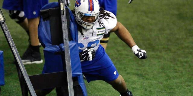 Buffalo Bills guard Cyril Richardson hits a sled during practice at the Detroit Lions NFL football training facility in Allen Park, Mich., Friday, Nov. 21, 2014. They'll use the facility in preparation for Monday's game against the Jets, which was moved to Detroit because of the snowstorm in Buffalo. (AP Photo/Carlos Osorio)