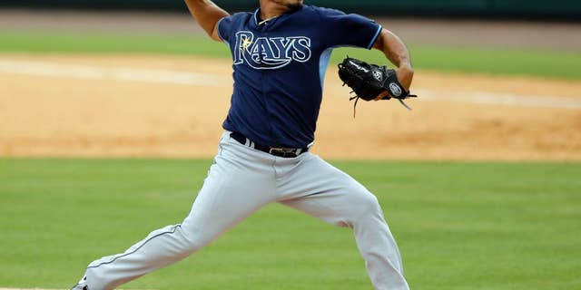 FILE - In this March 28, 2014, file photo, Tampa Bay Rays relief pitcher Joel Peralta throws during the sixth inning of an exhibition spring training baseball game against the Detroit Tigers in Lakeland, Fla. Peralta has been acquired by the Los Angeles Dodgers from the Bay Rays as part of a four-player trade announced Thursday, Nov. 20, 2014. (AP Photo/Carlos Osorio, File)