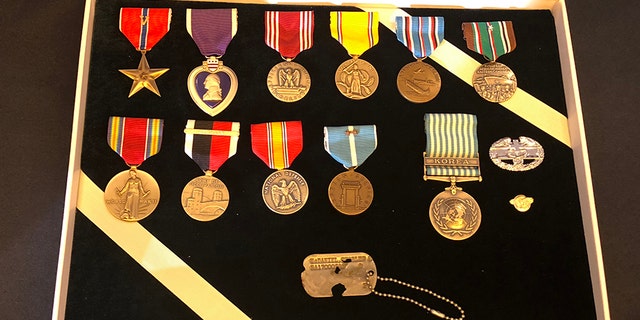 Master Sgt. Charles Hobert McDaniel's dog tag and other medals to presented to his two sons.
