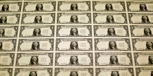 A sheet of the front side of United States one dollar bills is seen during production at the Bureau of Engraving and Printing in Washington November 14, 2014.