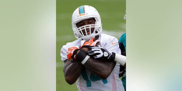 Miami Dolphins wide receiver Jarvis Landry holds on to the ball during NFL football training camp Saturday, July 26, 2014, in Davie, Fla. Training camp has barely begun, and Miami Dolphins rookie receiver Jarvis Landry has already showed an ability to catch the ball and the boss' eye. When team owner Stephen Ross was asked what player he's most excited to see this season, he named Landry, the second-round draft choice from Louisiana State. During offseason drills and the first two days of camp, Landry has impressed the Dolphins with his sure hands and ability to get open. (AP Photo/Alan Diaz)