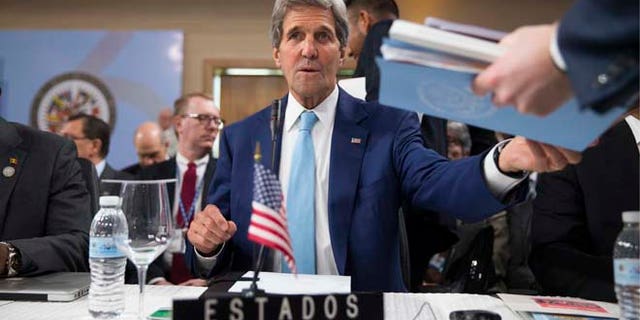 Secretary of State John Kerry is handed notes as he sits down for the General Assembly of the Organization of American States, Tuesday, June 14, 2016, in Santo Domingo, Dominican Republic. (AP Photo/Evan Vucci, Pool)