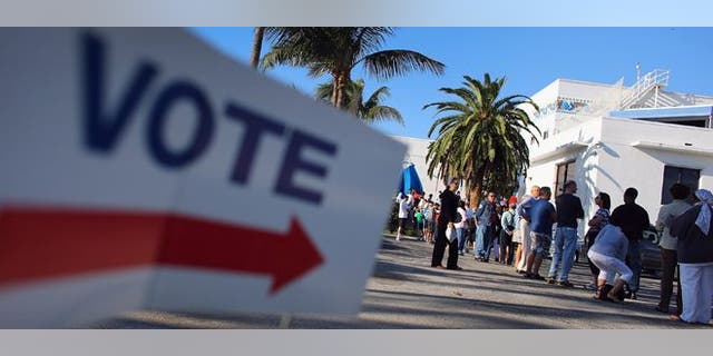 MIAMI, FL - OCTOBER 27: Early voters wait in line to vote in the presidential election on the first day of early voting at a polling station setup at the City of Miami City Hall on October 27, 2012 in Miami, Florida. Early voting in one of the important swing states is held for eight straight 12-hour days, leading up to the November 6 general election. (Photo by Joe Raedle/Getty Images)