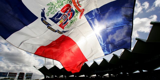 SAN JUAN, PUERTO RICO - MARCH 13: A fan flies the Dominican Republic flag during the game against Cuba during Round 2 of the World Baseball Classic on March 13, 2006 at Hiram Bithorn Stadium in San Juan, Puerto Rico. (Photo by Al Bello/Getty Images)