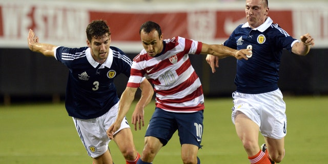 JACKSONVILLE, FL - MAY 26: Landon Donovan #10 of Team USA , is defended by Charlie Mulgrew #3 and Scott Brown #8 of Team Scotland on May 26, 2012 at EverBank Field in Jacksonville, Florida. (Photo by Gary Bogdon/Getty Images)