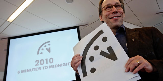 Lawrence Krauss, co-chair of the Bulletin of Atomic Scientists Board of Sponsors poses with a graphic image of the "Doomsday Clock" during a news conference.