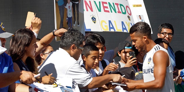 Los Angeles Galaxy forward Giovani dos Santos signs autographs before his first training with the MLS soccer team in Carson, Calif., on Tuesday, Aug. 4, 2015. After four years of courting dos Santos, the Galaxy signed the highest-profile Mexican star in their history to a designated player contract, paying a reported $7 million transfer fee. He will make his Major League Soccer debut on Sunday against the Seattle Sounders FC. (AP Photo/Nick Ut)