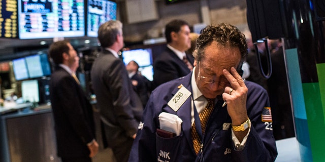 NEW YORK, NY - DECEMBER 04: A trader works on the floor of the New York Stock Exchange on December 4, 2013 in New York City. The Dow Jones Industrial Average dipped over 100 points during trading before bouncing back to approximately 15,900; the market peaked at a record high last month at over 16,000 points. (Photo by Andrew Burton/Getty Images)