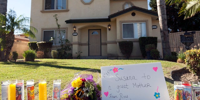 Oct. 25, 2012: Tributes are seen outside the home of a family targeted by a gunman in Downey, Calif.