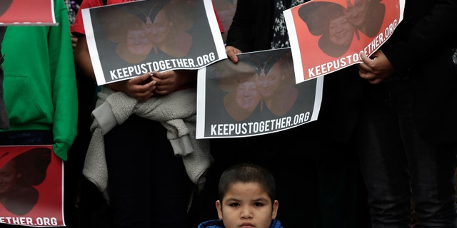A child listens at a press conference held by the Dream Action Coalition on immigration reform on December 4, 2013 in Washington, DC. (Photo by Win McNamee/Getty Images)